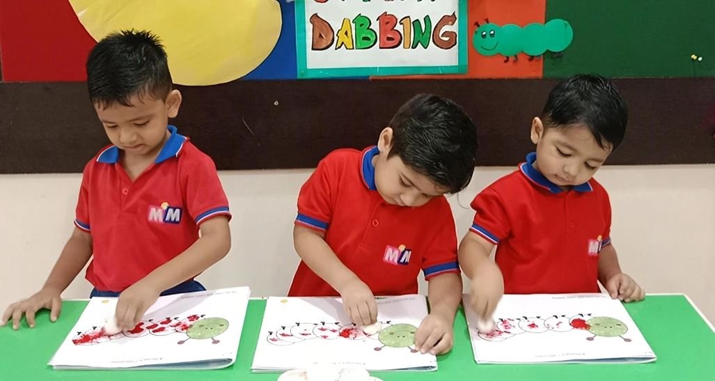 Children doing a cotton dabbing art activity