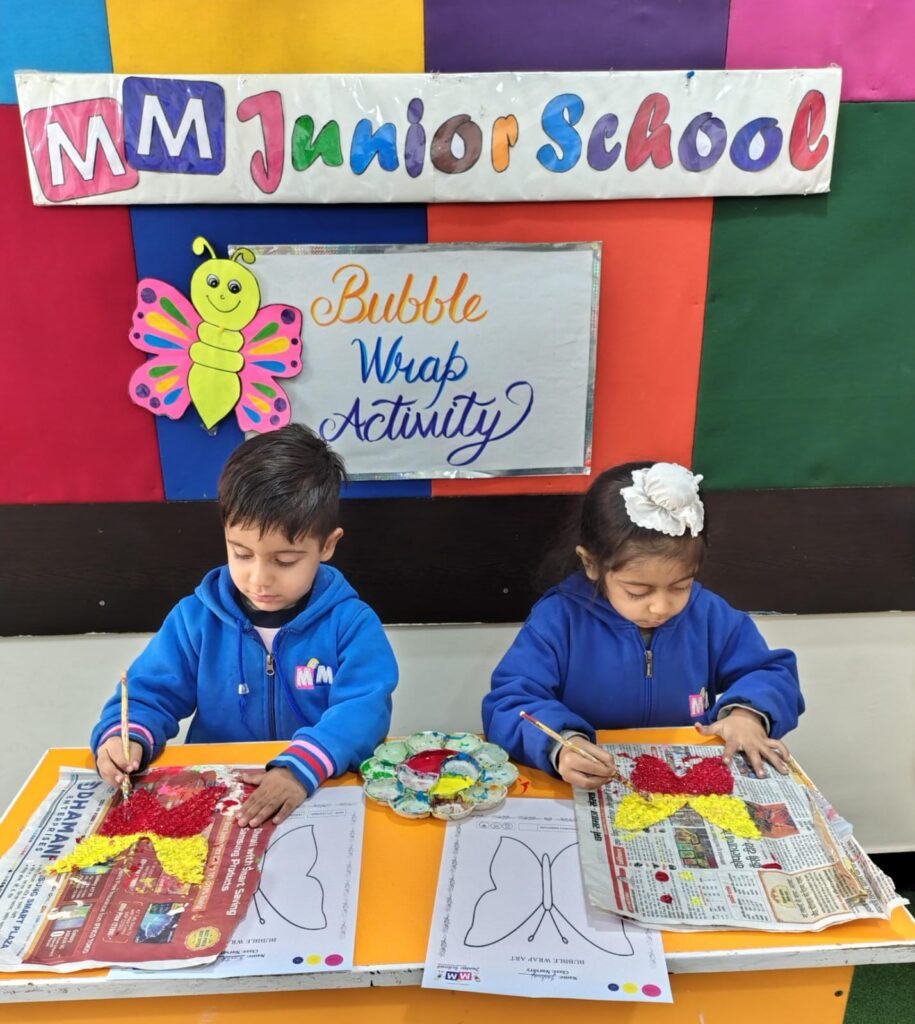 Two children painting during the bubble wrap activity